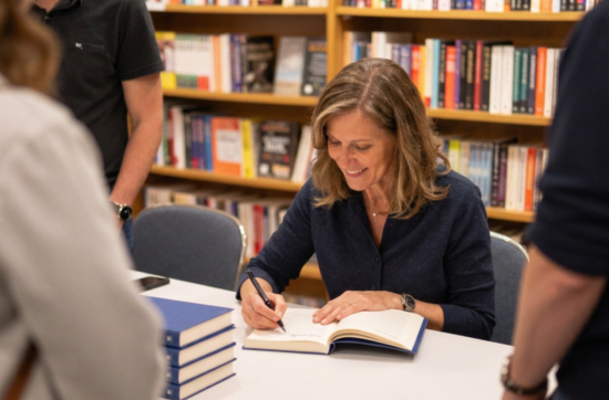 author at book signing Publish and Promote